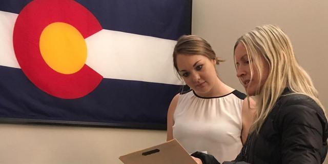 Herd on the Hill volunteer talking to a staffer for a Colorado senator about a constituent letter