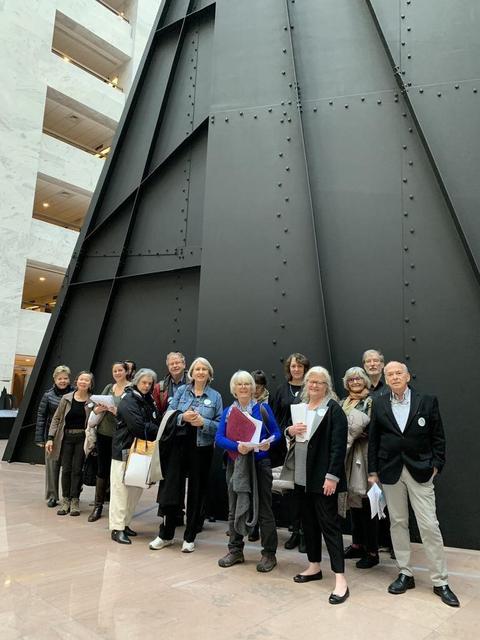 Herd on the Hill volunteers in the atrium of the Hart Senate Office Building with piles of letters to deliver to senators